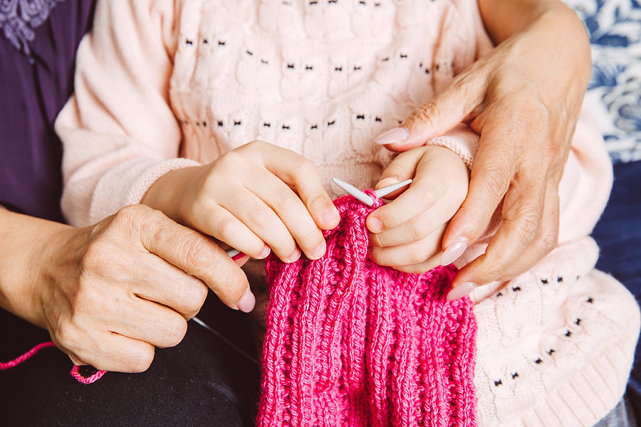Closeup of knitting hands of grand daughter Photograph by Images By Tang Ming Tung