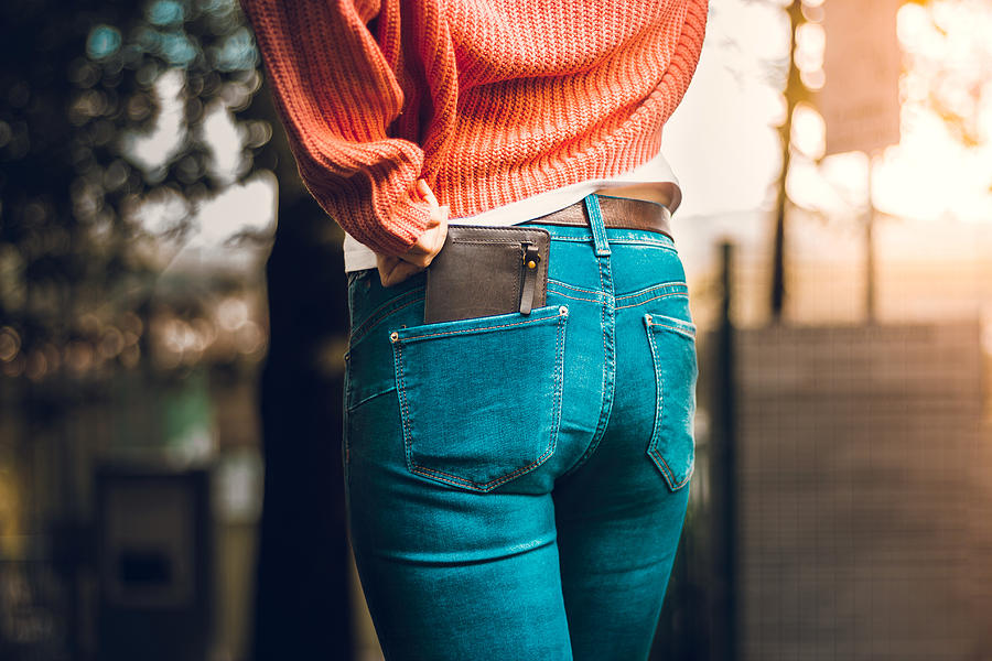 Closeup shot from behind of woman in jeans with wallet in the pocket Photograph by Madrolly