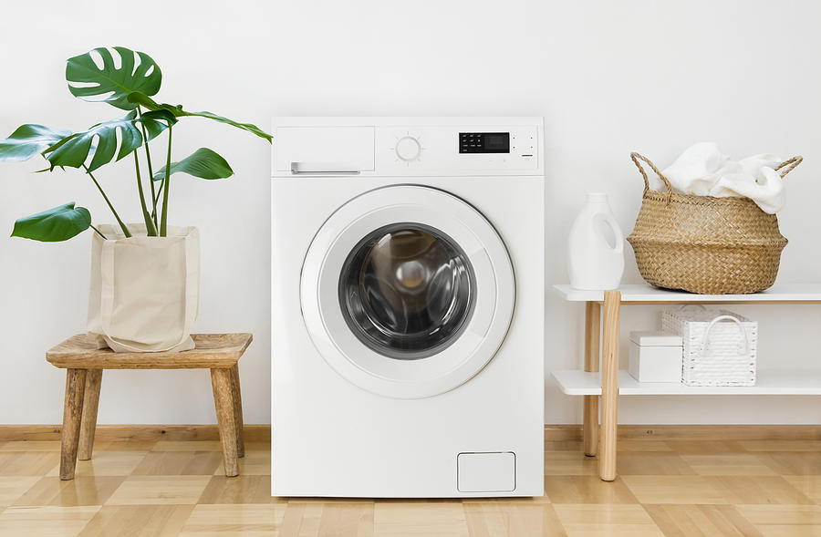 Clothes washing machine in laundry room interior Photograph by Didecs