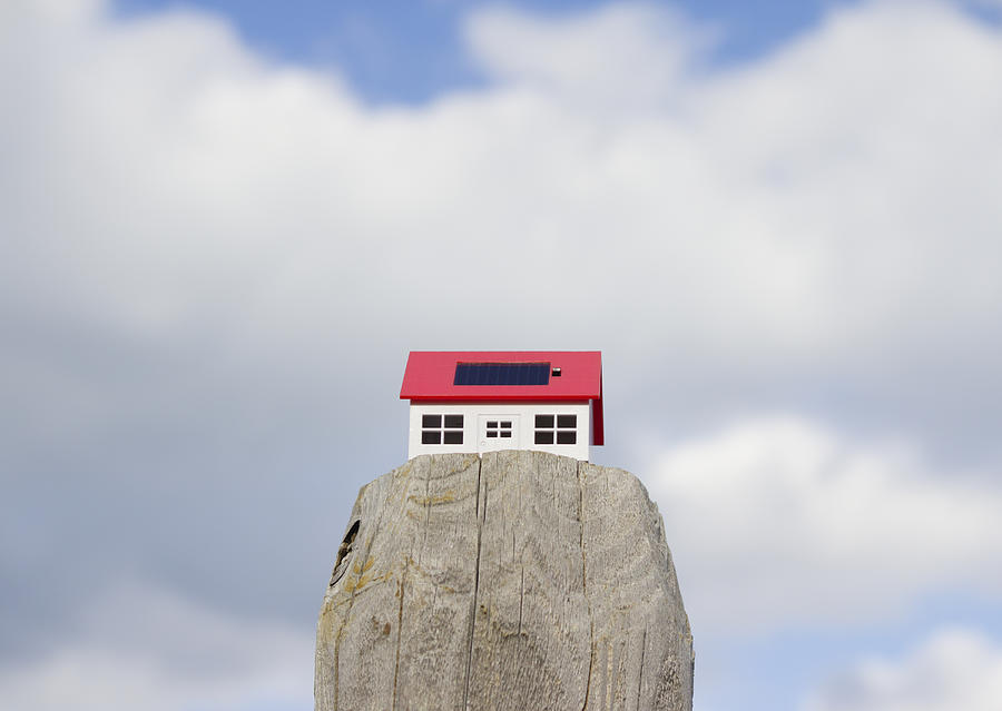 Clouds and a miniature solar home Photograph by Imagenavi