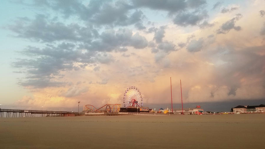 Clouds at Sunrise over Jolly Roger at the Pier Photograph by Robert Banach