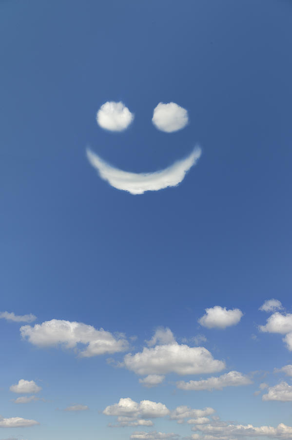 Clouds forming smiley face in sky Photograph by Tetra Images