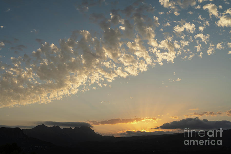 Clouds, golden sunlight and the Sierra de Bernia mountain range Photograph by Adriana Mueller