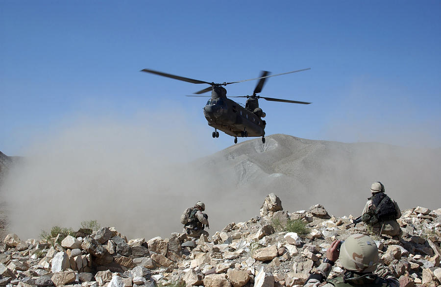 Clouds of dust kicked up by the rotor wash of a CH-47 Chinook helicopter in Afghanistan. Photograph by Stocktrek Images