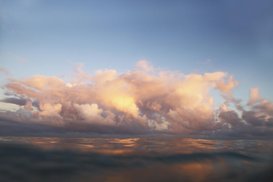 Clouds over sea at sunrise Photograph by Gary John Norman