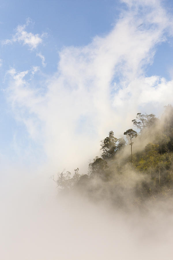Clouds rising over mountain top Photograph by Merten Snijders