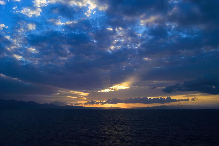 Cloudscape over the sea at dusk, Milne Bay, Papua New Guinea Photograph by Glowimages