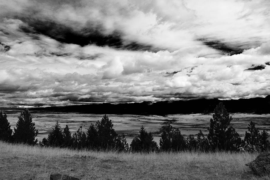 Cloudy sky against landscape Photograph by Monica Simpson / FOAP
