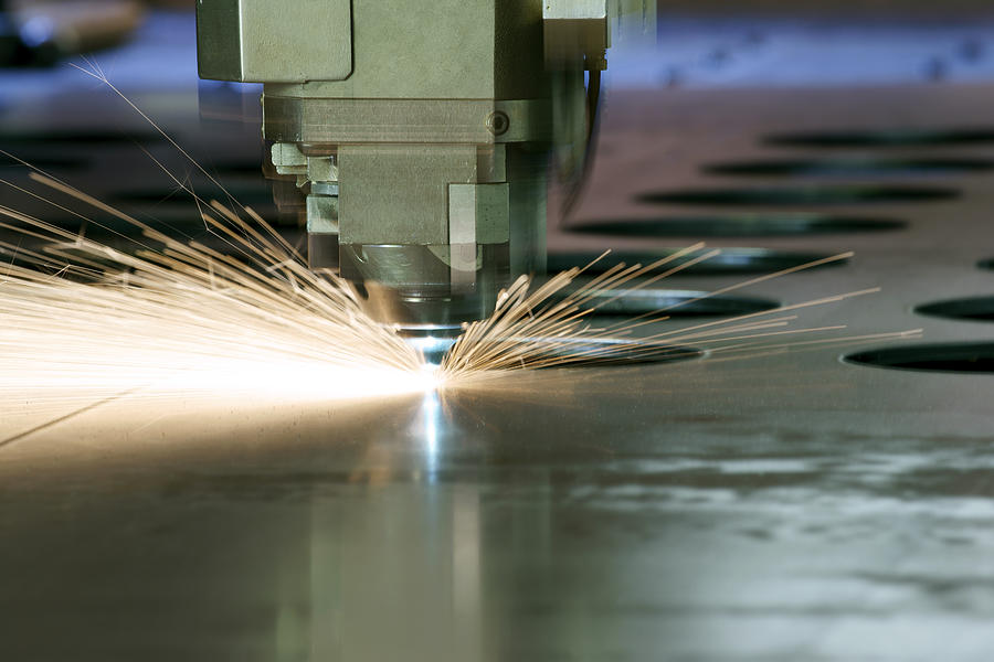 CNC laser metal cutting machine tool in operation Photograph by Fertnig
