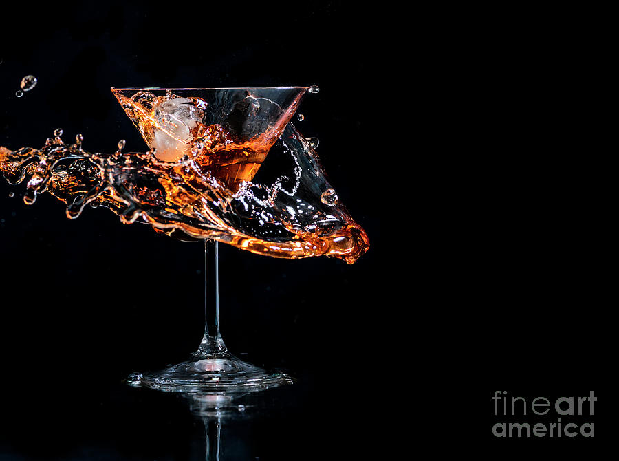 Cocktail Splash In Martini Glass Over Black Background With Copy Photograph