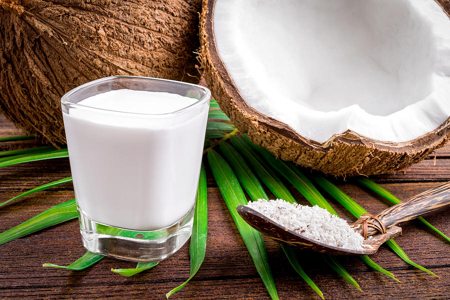 Coconut and coconut milk in glass Photograph by Aedkais