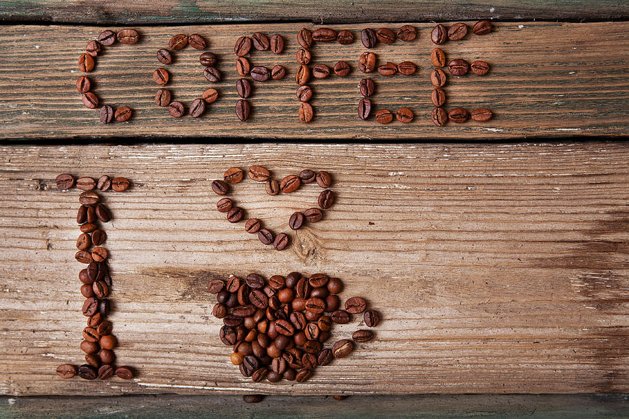 Coffee Beans And Cup With Heart On Wooden Background Photograph by Ellemarien