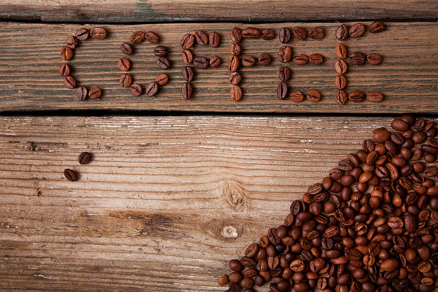 Coffee Beans On Wooden Background Photograph by Ellemarien