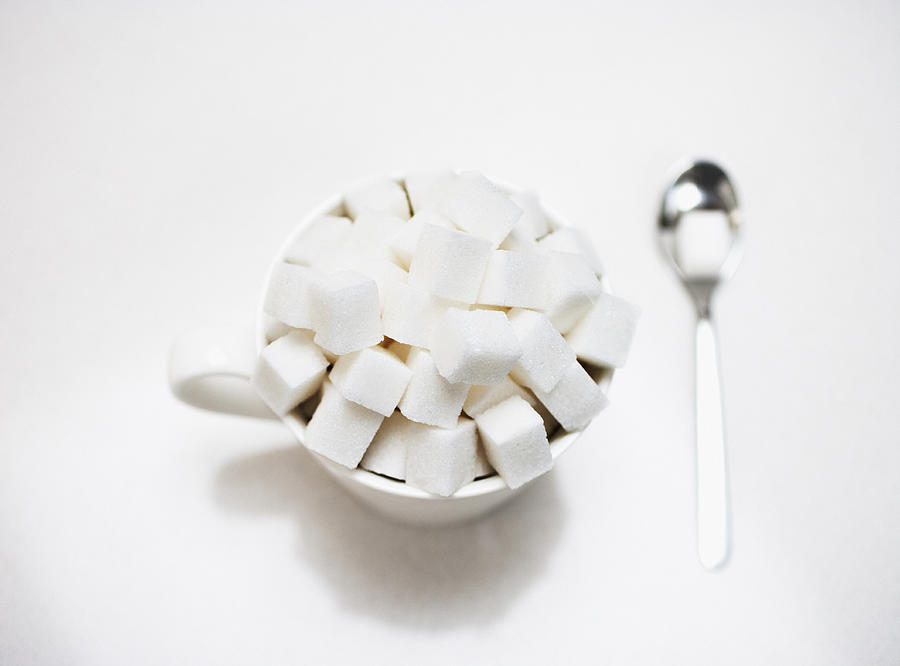 Coffee cup filled with sugar cubes Photograph by Robert Daly