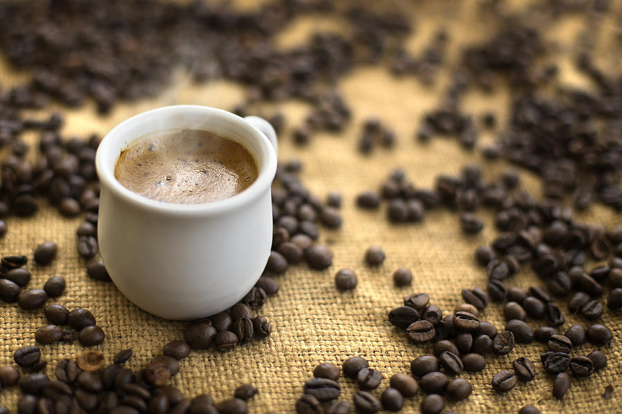 Coffee Drink In Cup On Coffee Beans Background. Photograph by Stefka Pavlova