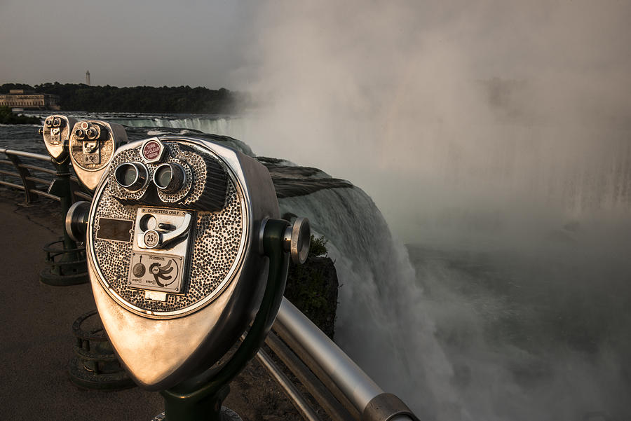 Coin-operated binoculars against Niagara falls Photograph by Cavan Images