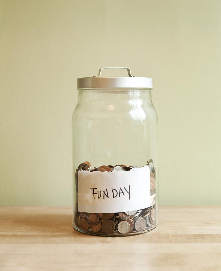 Coins in fun day jar Photograph by Sam Diephuis