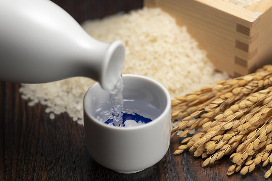 Cold sake with rice and ear of rice on the table Photograph by Kuppa_rock