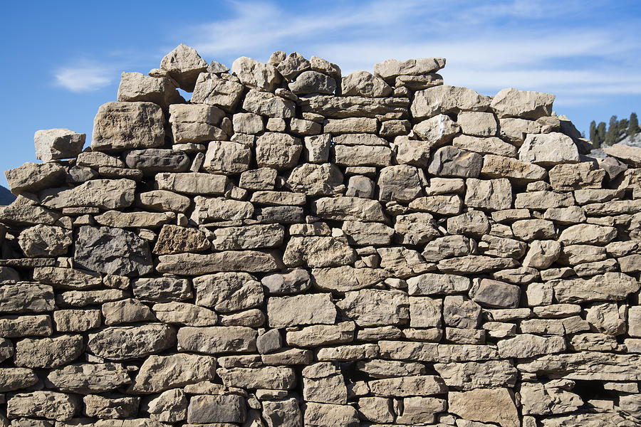 Collapsed dry stone wall against blue sky Photograph by Carlos Ciudad Photography