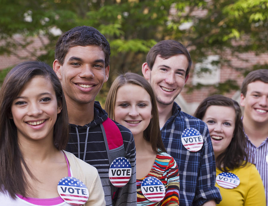 College students wearing vote buttons on campus Photograph by Ariel Skelley