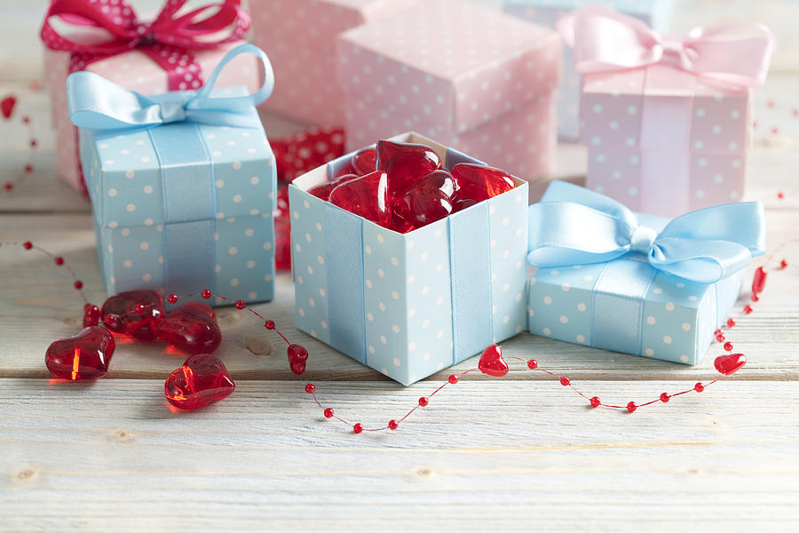 Colored gift boxes and red hearts on wooden planks Photograph by Tedestudio