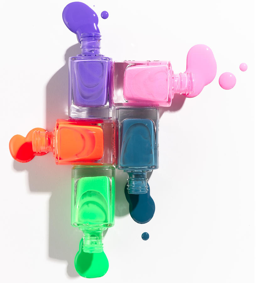 Colored Nail Polish Spilling From Bottles Photograph by Cathy Crawford