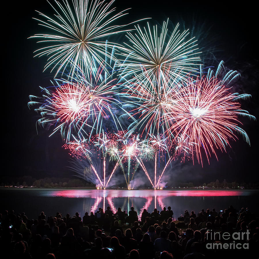 Holiday Photograph - Colorful big fireworks on river with crowd silhouette by Gregory DUBUS