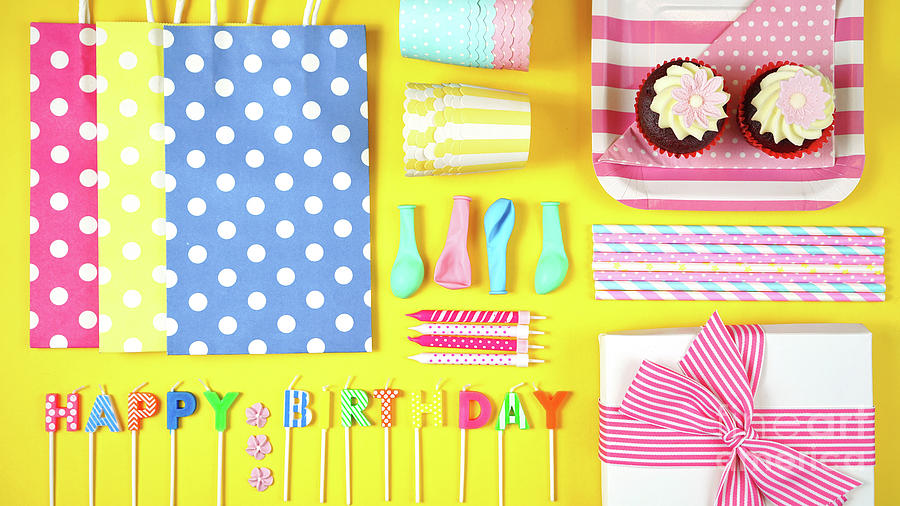 Colorful birthday party flat lay on yellow background. Photograph by Milleflore Images