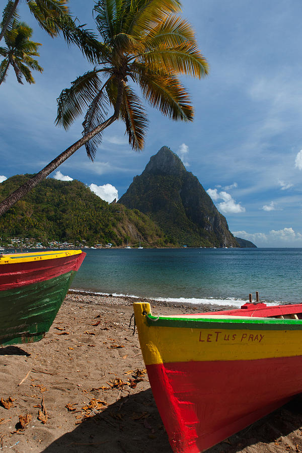 Colorful boats on the beach in  Soufrieire, St Lucia with the Pitons in the background.The famous Pitons of St Lucia are volcanic plugs rising out of the sea at the south end of the island. Photograph by Reed Kaestner