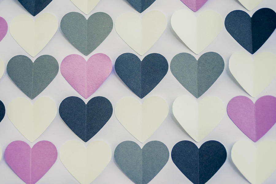 Colorful heart shaped papers on white background. Photograph by Malorny