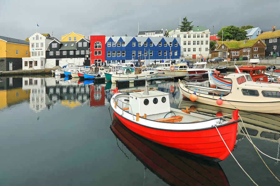 Colorful houses around a small fishing harbor with colorful boats Photograph by Rainer Grosskopf