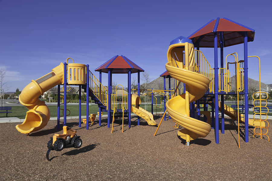 Colorful kids outdoor playground equipment with slides Photograph by Ron and Patty Thomas