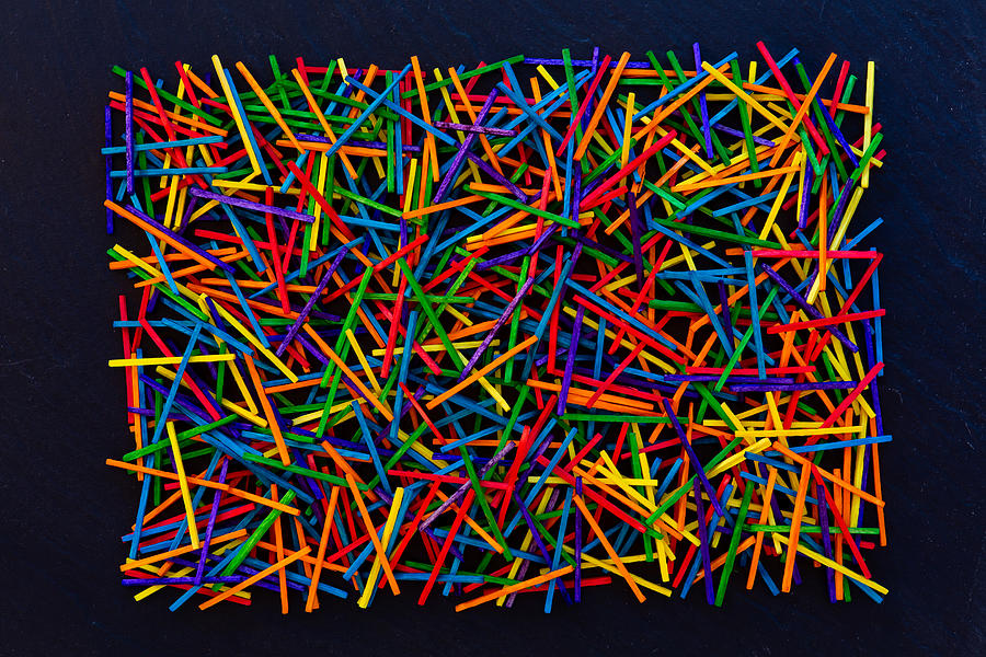 Colorful matches / wooden sticks on black rock tile Photograph by Baac3nes