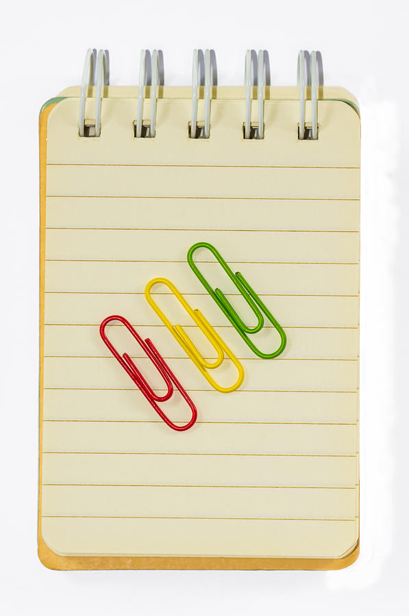 Colorful paperclips and note book on white background isolated Photograph by Phongphan5922
