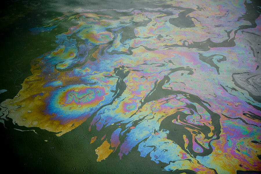 Colorful patterns in an oil slick on water Photograph by P_Wei