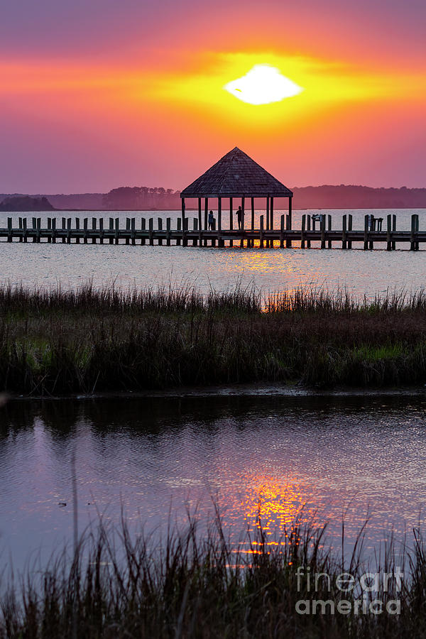 Colorful sunset over Assawoman Bay on the bay side of Ocean City Photograph by William Kuta
