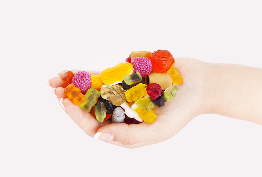 Colorful Sweets mix in woman hand Photograph by Deepblue4you