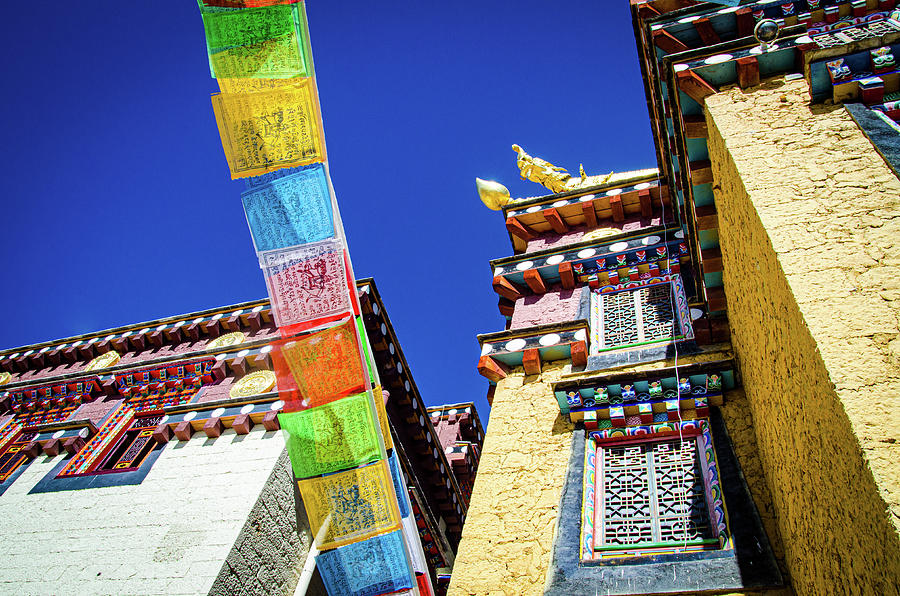 Colorful Tibetan monastery with prayer flags spreading good fortune  Photograph by Adelaide Lin