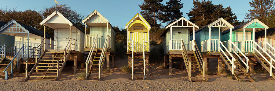 Colorful wells next the sea beach huts England Photograph by Sonny Ryse