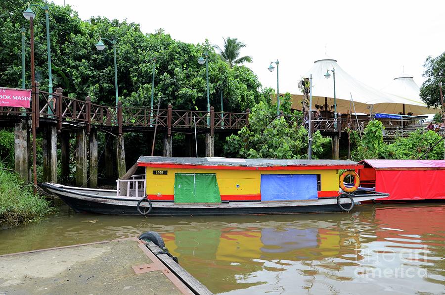 Colorful yellow river taxi ferry boat parked on Sarawak River Kuching East Malaysia Photograph by Imran Ahmed