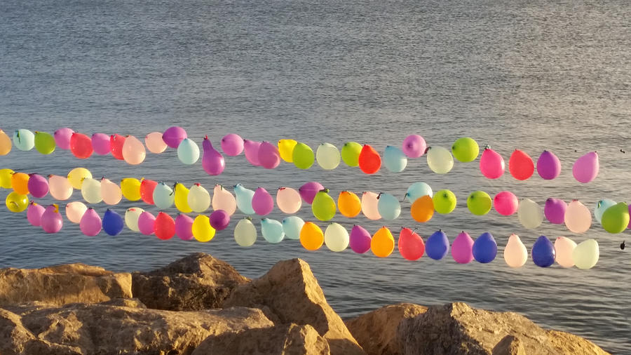 Colourful balloons over rock Photograph by Tatiana Demir / FOAP
