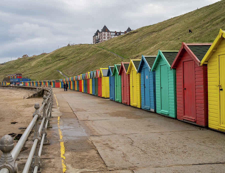 Colourful beach huts on Whitby promenade, North Yorkshire Photograph by ...