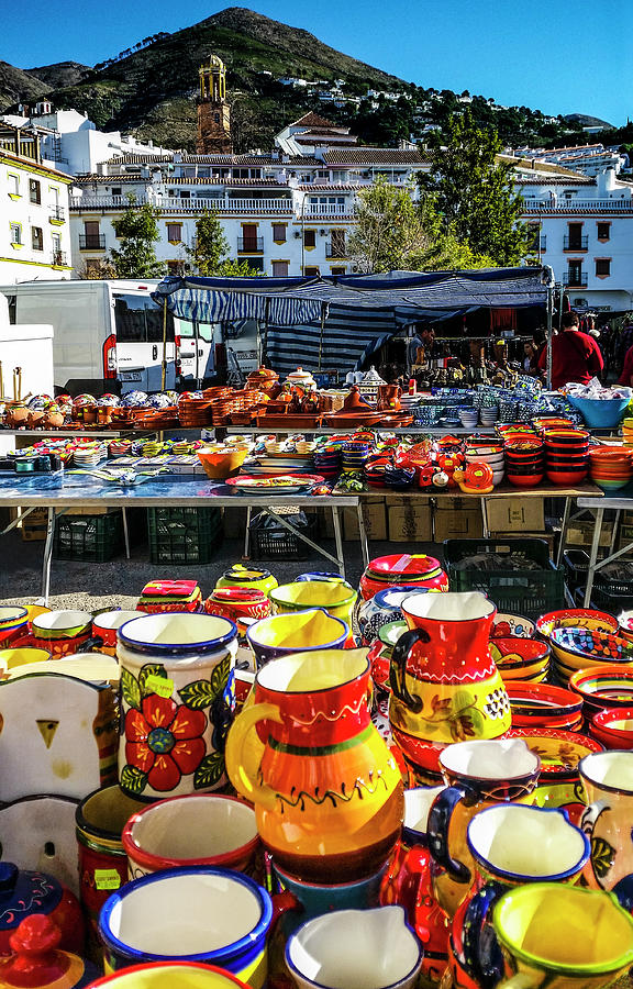 Colourful ceramics in Competas Street Market with the village and mountain in behind, Malaga Photograph by Panoramic Images