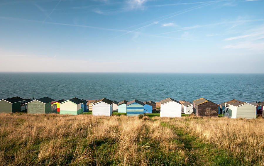 Colourful Holiday Wooden Beach Huts Facing The  Sea. Photograph