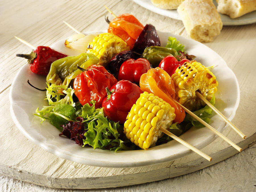 Colourful vegetable kebabs on salad leaves, close up Photograph by Foodcollection RF