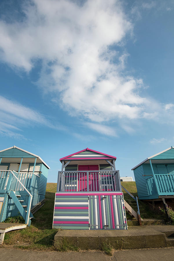 Colourful wooden beach huts facing the ocean at Whitstable coast Photograph by Michalakis Ppalis