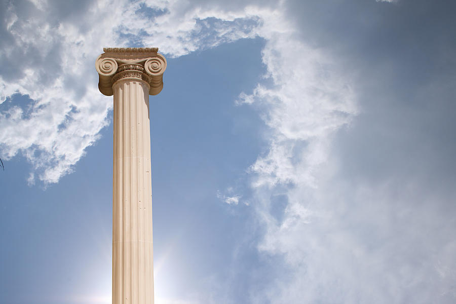 Column against cloudy sky Photograph by PhotographerOlympus