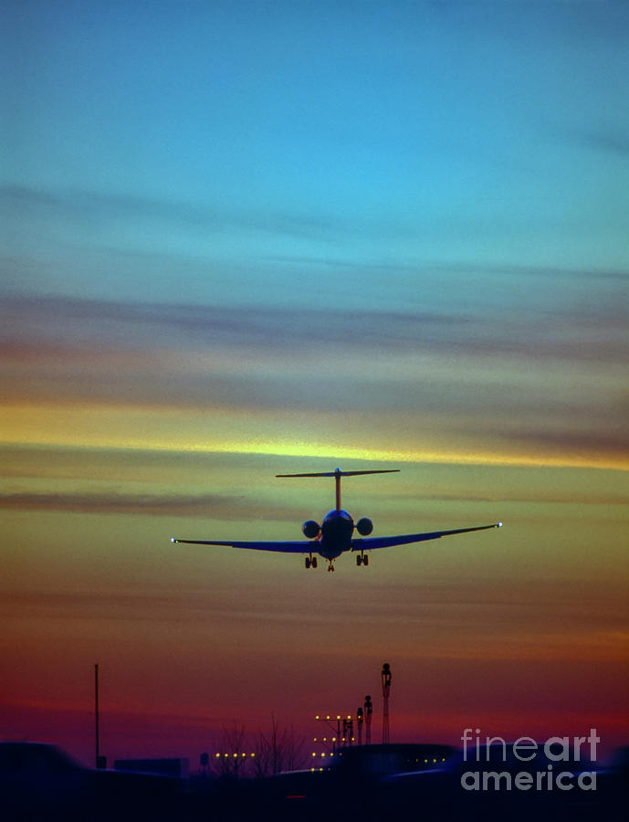 Comercial Airliner landing into the sunset approach lights DC9 5 Photograph by Tom Jelen