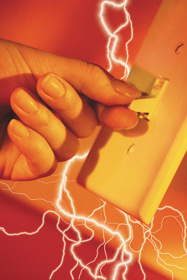 Composite of lightning bolts and fingers flicking a light switch on Photograph by Comstock