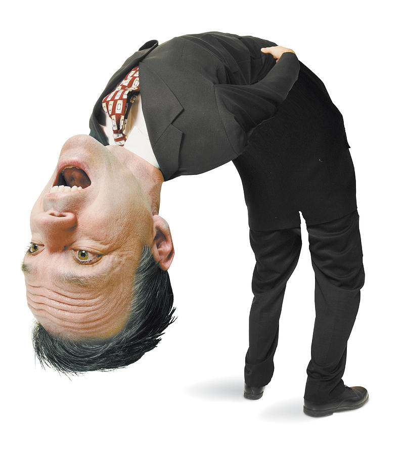 Conceptual Caricature Of A Caucasian Man In A Suit As He Literally Bends Over Backwards Photograph by Photodisc